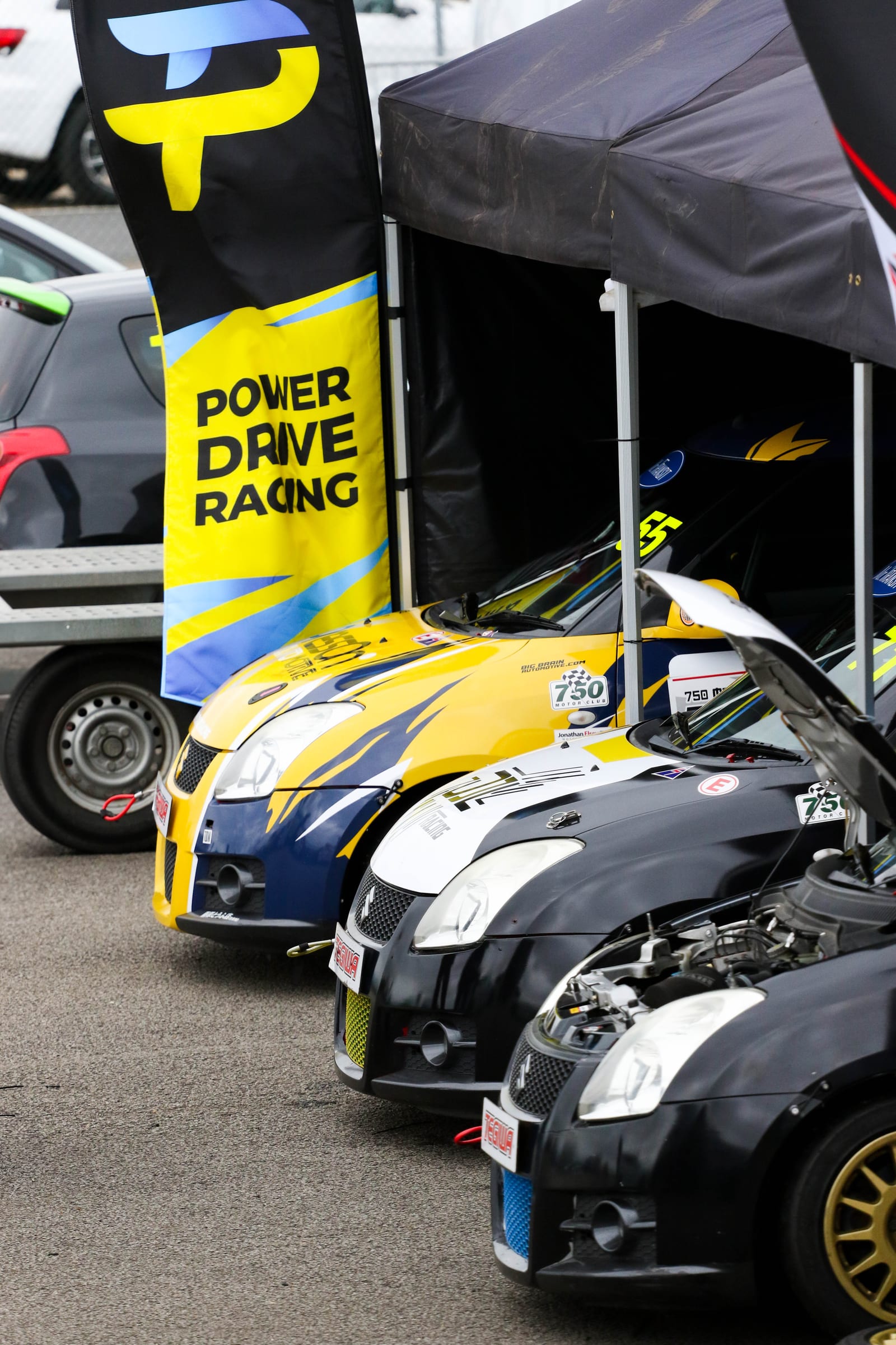PowerDrive Racing team member during paddock setup